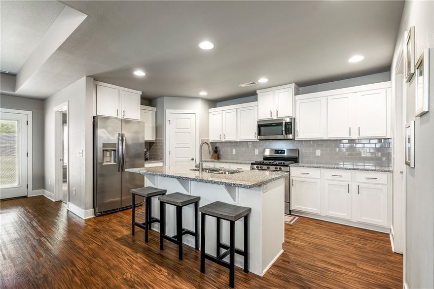 Picture this: bike rides to Lake Fayetteville, splashpad at Willie George Park, & weekend walks on the Razorback Greenway—all just minutes from your door. This 2022-built gem isn’t just a house, it’s a clean slate. Lightly lived-in, pet-free, & professionally cleaned & landscaped, it feels brand new. Tucked on a low-traffic street w/no immediate backyard neighbor, enjoy added peace & privacy. Whether you're starting a family, scaling down, or adding to your portfolio, this spot delivers convenience—just 5 mi to Tyson HQ & I-49. Inside, gather around the gas fireplace, cook in the bright kitchen w/granite, gas range, stainless appliances, & coffee nook. Durable vinyl floors in the main areas w/carpet in the bedrooms for comfort. The primary suite is your retreat—soaker tub, double vanity, oversized closet, & custom tile shower. Out back, the fenced yard & covered patio are perfect for quiet mornings or lively evenings. It’s more than a move—it’s your next chapter.