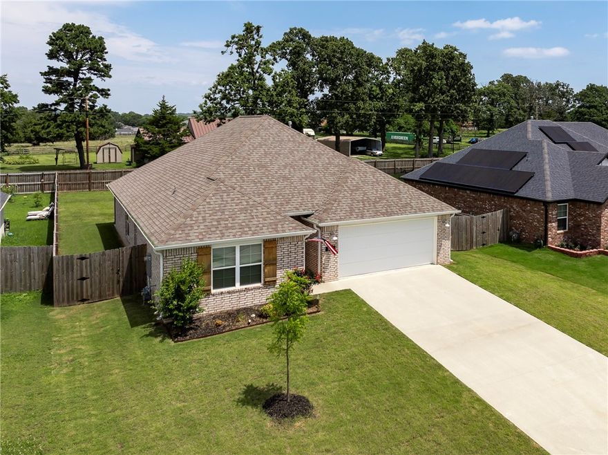 Picture this: bike rides to Lake Fayetteville, splashpad at Willie George Park, & weekend walks on the Razorback Greenway—all just minutes from your door. This 2022-built gem isn’t just a house, it’s a clean slate. Lightly lived-in, pet-free, & professionally cleaned & landscaped, it feels brand new. Tucked on a low-traffic street w/no immediate backyard neighbor, enjoy added peace & privacy. Whether you're starting a family, scaling down, or adding to your portfolio, this spot delivers convenience—just 5 mi to Tyson HQ & I-49. Inside, gather around the gas fireplace, cook in the bright kitchen w/granite, gas range, stainless appliances, & coffee nook. Durable vinyl floors in the main areas w/carpet in the bedrooms for comfort. The primary suite is your retreat—soaker tub, double vanity, oversized closet, & custom tile shower. Out back, the fenced yard & covered patio are perfect for quiet mornings or lively evenings. It’s more than a move—it’s your next chapter.