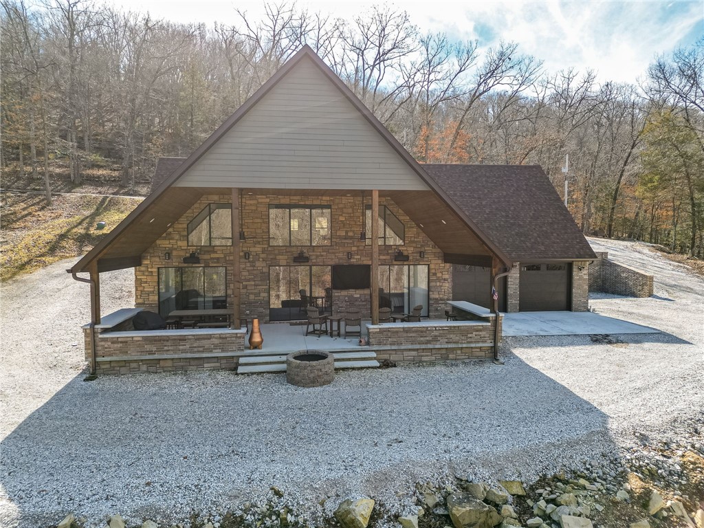 This is an AMAZING opportunity to own a new construction home on the lake! The owner spared no expense on all of the finishes, windows, flooring & appliances, as well as a full house generator. As you walk in the glass sliding door, stop right there and take it all in, the vaulted ceiling, open floor plan encompasses the great room, gourmet kitchen, dining area, and the massive covered porch. The primary suite on the main level has gorgeous seasonal views with tons of natural light, and the spa like bath is a treat with a huge closet with built-ins for storage. Walking to the back of the main floor you'll notice the utility room to the right leading to the 2 car oversized garage. On the left is the first guest bedroom complete with an en suite bath. On the second level the landing is currently being used as game room for guests. Left are 2 bonus rooms which sleep 8 comfortably. As you stroll down the hallway, is the 2nd guest bedroom complete with an en suite bath. This home has 2 10x26 slips in a 4 slip dock.