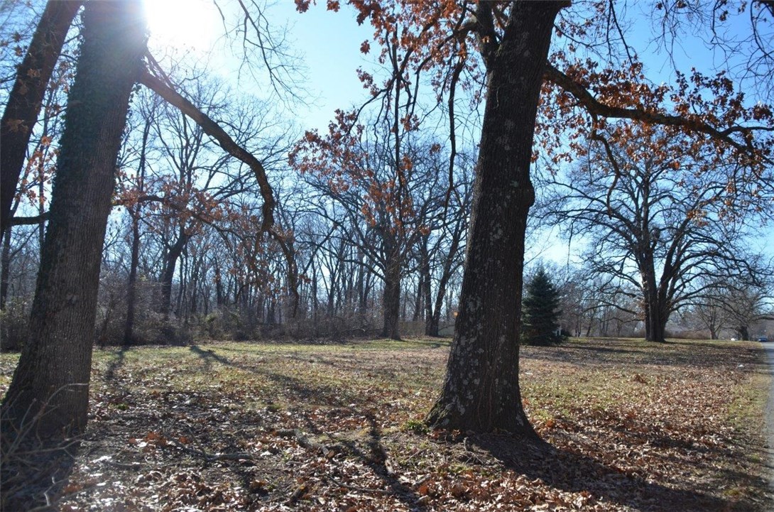 Beautiful lot with mature trees - area of nice homes, close to I-49 & Promenade Mall. Buyer to verify utility locations.