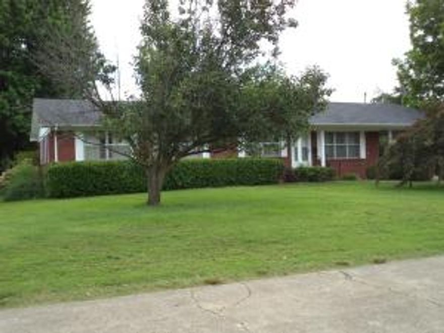 NEED 4 BEDROOMS?  Take a look at this spotless 4 bedroom 2 bath brick home in town Clarksville.  Maintenance free, large rooms, partial basement, lots of closet space and shop building in backyard.  Newly surveyed and loaded with azalea and rose bushes.