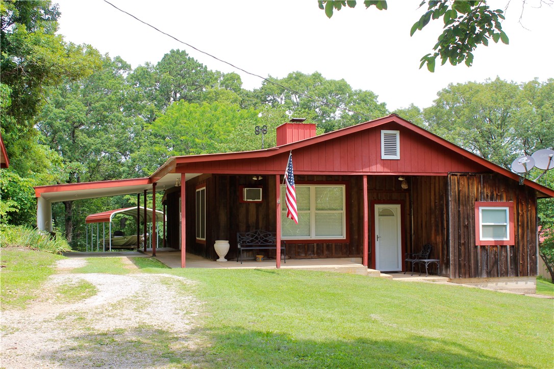 Charming 6+/- acre Ozark property just 6 minutes from Eureka Springs! This peaceful retreat features a 1,261+/- SQFT 2 bed, 1 bath home with tasteful updates completed in 2022, offering a cozy and modern living space surrounded by natural beauty. The home sits on paved road frontage and is framed by mature trees, flowering plants, and stunning mountain views. A spacious 1,040+/- SQFT shop provides ample room for hobbies, storage, or a small business. A greenhouse is in place for year-round gardening, and an underground storm shelter/cellar adds safety and practicality. With no known restrictions and plenty of space to expand, this property is perfect for those seeking a homestead, vacation home, or investment opportunity. The setting is private yet easily accessible, combining the serenity of country living with the convenience of several towns nearby. The property is also home to abundant wildlifeādeer, turkey, songbirds, and moreāoffering a perfect setting for nature lovers and outdoor enthusiasts.