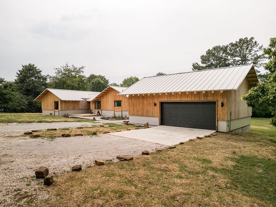 Architecturally designed home on a large lot in South Fayetteville. Offering privacy and a sense of seclusion, yet only minutes from dining, shopping, and the University. The 2,100 sq. ft. layout includes 3 bedrooms and 2 bathrooms, highlighted by a spacious primary suite. Originally built in 1961, the home has just undergone a complete transformation with a newly finished addition and full system upgrades—new HVAC, electrical, and plumbing. Custom cabinets, built-ins, wood flooring, and cedar siding are just a few of the design details that make this home stand out. Thoughtful details blend timeless character with modern convenience, creating a distinctive, high-quality home that is ready for everyday living and lasting enjoyment.