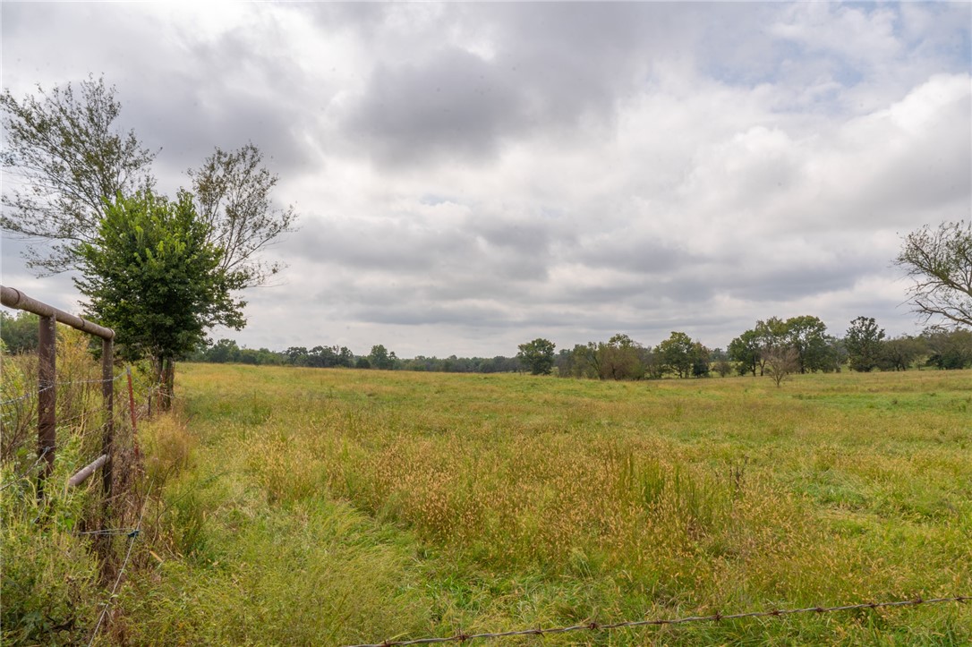 Acreage near XNA provides endless potential! Level land in fast-growing area is perfect for residential development, small farm or cattle operation, or commercial use. This prime location plus open possibilities equals a smart investment, offering a blank canvas to your vision, whether you want to farm, develop or invest in the future. Coming soon is Hwy 612 which exits at the XNA entrance making this property easily accessible to all of NWA.