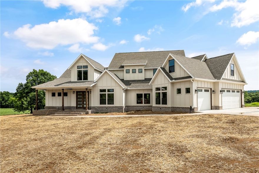 New home over looking the White River arm with a stunning backdrop of horses, cattle and the beautiful Ozark Mountains.  This home sits in a private gated community of only 7 lots.   Developer/builder lives in the subdivision.  Gorgeous home with immediate character and texture.  All brick steps lead to large and open foyer spilling into its open living/dining/kitchen area. Complete with wood burning fireplace and large windows, the details were not spared with Delta Champagne Bronze fixtures throughout with ample storage.  Silestone countertops in every room.  Double doors lead to walk-in pantry doned with farmhouse sink perfect for hosting.  Spacious laundry room with island and cabinets to the ceiling.  Mud room off the back porch with powder bath.  Guest room complete with full tiled shower. Master Suite with back porch access and gorgeous tile work in the bathroom.  Three bedrooms upstairs with two full baths and full tiled showers. Large bonus room enclosed by custom double barn doors and more storage.