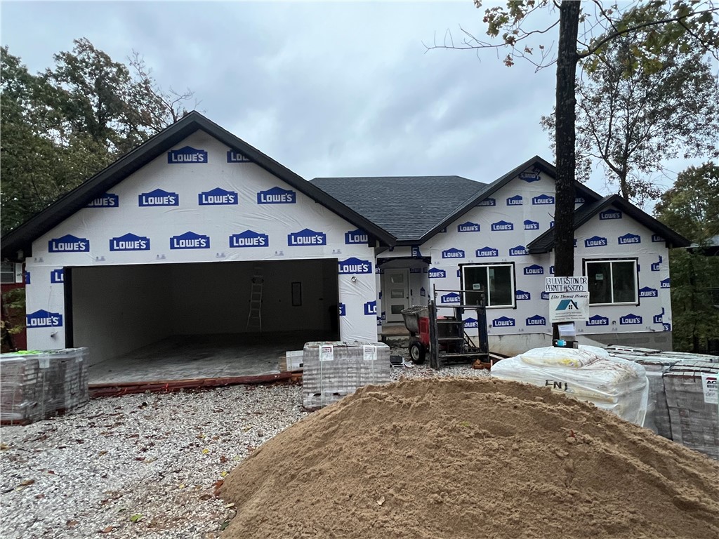 Beautiful new construction by Elite Thomas Homes conveniently located just off Lancashire Blvd! Enjoy easy access to some of areaās best outdoor recreationāonly 0.2 miles to the Flo Ride Trailhead, 0.8 miles to the Back 40 Trailhead, and 1.6 miles to Lake Ann. Get under contract quickly to still be able to personalize your interior selections, including paint colors, flooring and countertops and to choose from available upgrades. Estimated completion mid-December. This single-level home offers 3 bedrooms and 2 baths with a vaulted ceiling accented by beams in the main living area and a stacked-stone vent-free fireplace. The open-concept layout connects the kitchen, dining, and living spaces seamlessly, while the split floor plan provides privacy for the primary suite. Enjoy wood flooring throughout the main areas, hallways, and primary bedroom and closet, with carpet in bedrooms two and three. Step out from the kitchen onto the covered and uncovered deck and take in the peaceful wooded views.