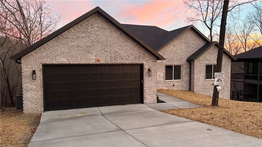 Construction is complete! This beautiful new build by Elite Thomas Homes is ideally located just off Lancashire Blvd with quick access to some of the area’s best outdoor recreation—only 0.2 miles to the Flo Ride Trailhead, 0.8 miles to the Back 40 Trailhead, and 1.6 miles to Lake Ann. This thoughtfully designed single-level home offers 3 bedrooms and 2 bathrooms, featuring a vaulted ceiling with beams in the main living area and stacked-stone, vent-free gas fireplace. The open-concept layout connects the kitchen, dining, and living spaces, while the split floor plan provides added privacy for the primary suite. The kitchen showcases Sedona Brush granite countertops paired with classic white brick subway tile. Wood flooring flows through the main living areas, hallway, and primary bedroom and closet, with plush carpet in bedrooms two and three. Step out from the kitchen onto the spacious deck—offering both covered and uncovered areas—and enjoy peaceful wooded views,perfect for morning coffee or entertaining friends.