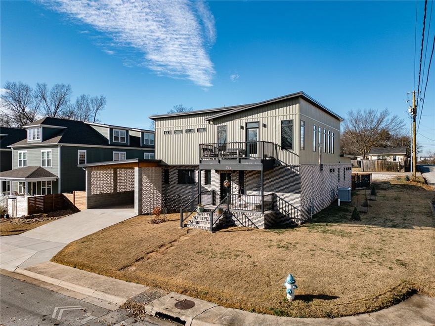 This one-of-a-kind modern home is just down the hill from the Downtown Square, close to Crisis Brewing and Feed & Folly. Designed for both style and function, it features 3 bedrooms, 3.5 baths, and a versatile upstairs rec room. Both upstairs bedrooms offer exterior access and can be separated for privacy or flexible use.

Inside, standout details include a striking custom metal staircase, a thoughtfully designed dog wash station in the mudroom, wood-framed windows, a pot filler in the kitchen, and custom countertops crafted from recycled glass and resin.

The home’s outdoor spaces are equally impressive, with front porches, back balconies, a large backyard, and a built-in bar perfect for entertaining. Parking is easy with a 2-car carport and a detached garage already plumbed for future ADU conversion.

For buyers seeking something unique with nothing like it on the market, this home blends modern design, functional details, and a prime South Fayetteville location in a truly special package.