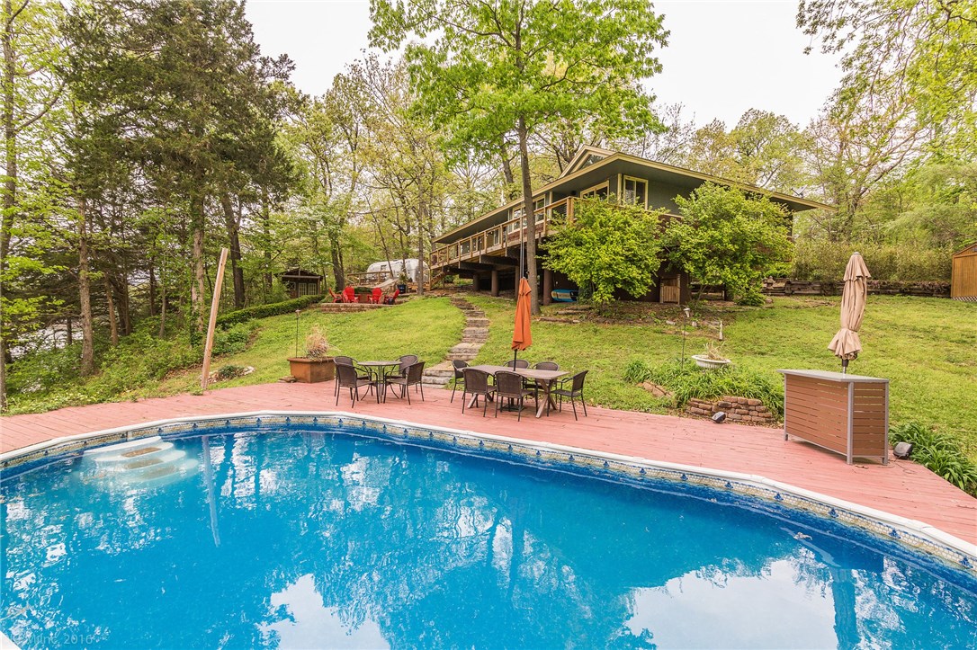 LAKE FRONT PROPERTY! AWESOME CUSTOM 3BD/2BA HOME ON 1.13 ACRES. PRIVATE BOAT DOCK, SWIMMING POOL AND AIRSTREAM GUEST SUITE. ART STUDIO AND BEAUTIFUL PROPERTY TO PROVIDE INSPIRATION! BEAUTIFUL INTERIOR WITH WOOD FLOORS, BUILT INS, CUSTOM LIGHTING, AND VAULTED CEILINGS. 11X11 SCREENED IN PORCH AND 364SQFT LOFT FOR ENJOYING BEAUTIFUL SUMMER NIGHTS. OUTDOOR FIRE PIT PATIO. PERFECT HOME FOR ENTERTAINING! DONT MISS THIS GORGEOUS HOME! NEW A/C!