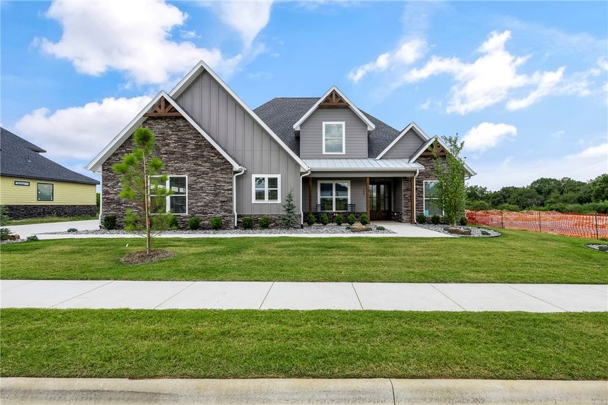 Stunning New Construction with a Best-Selling Floorplan in the sought after Big Sky Subdivision!  All the quality and extras you expect throughout from one of the top builders in NW Arkansas.  Large light-filled open living space featuring a gourmet kitchen with huge island, tons of cabinets, double ovens, gas cook-top and butler’s pantry. Downstairs also features the Master suite, formal dining, office or optional 5th bedroom.  Upstairs features 3BRS, 2BA and large media/game room with built-in wet bar.  Covered back patio, complete home security system and smart home wired. Professionally landscaped, sodded yard and sprinkler system. Home is complete and move in ready! No time to wait!