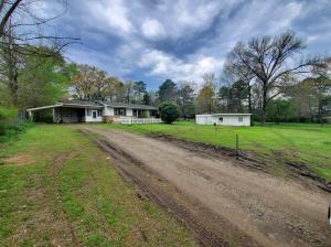 Perfect investment property sitting right across the lake on Hwy 22! Come see what all this house has to offer! House and buildings come's as is where is.
