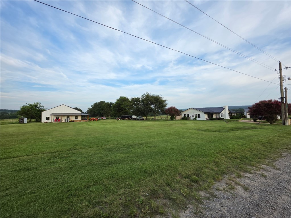 The ARKANSAS HOBBY FARM of YOUR DREAMS--Complete with a new 3360 sq. ft shop w/water & electricity (Has an unfinished apartment)! Sits on 8+ acres, fenced. Stunningly UPDATED dwelling offers a new metal roof, CHEF'S massive kitchen with luxury appliances, new flooring, new master bath, 5 ton York CHA unit, solid black walnut cabinets. 16.8 KW grid tied solar system (currently runs both the NEWER shop and house).6 car garages. New shop hosts a 10 X 12 walk in safe room w/vault door, 1696 sq ft of unfinished loft space, 708 sq ft living quarters, three 10x12 bay doors, two 7x8 bay doors.Home has a wood-burning fireplace that is ducted throughout the house. Also has a propane fireplac