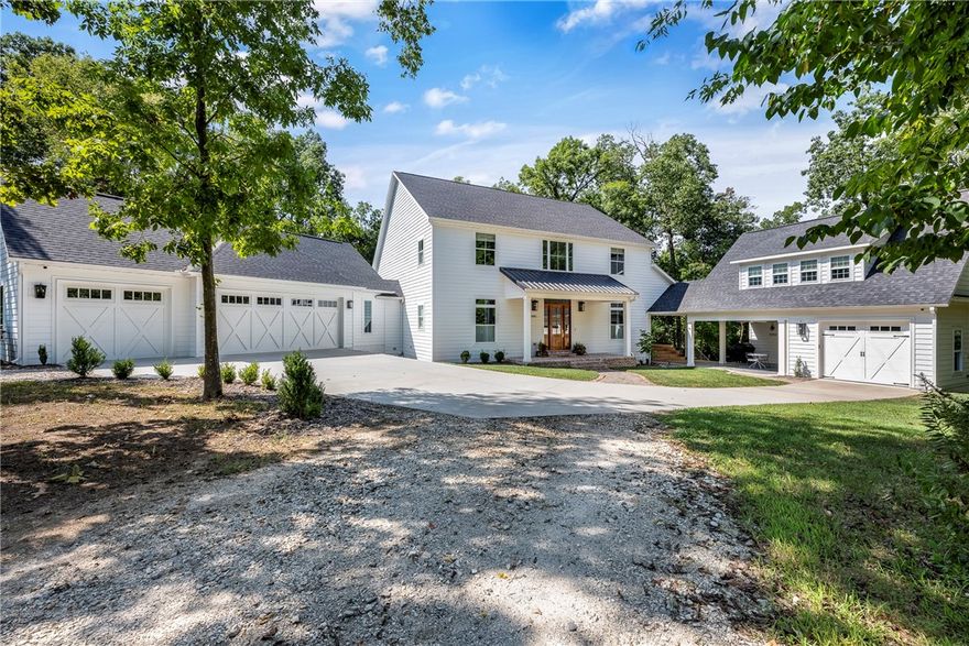 This custom built estate is located on hard to find 2.2 acres in the most coveted location in the Bentonville area, adjacent to Scissortail and just down the road from Shadow Valley, Pinnacle CC and Evening Star Elementary. On the property you will find the main house and attached mother in law house. The main house includes a gourmet kitchen featuring Bertazzoni appliances, walk in pantry, island and coffee bar. The Master suite is on the main level and includes a sitting area, huge walk in closet, tile shower and soaking tub. The main level also includes a library, office nook, formal dining room with wood burning fireplace and living room. The 2nd floor includes well appointed spare bedrooms, including an ensuite, and a bonus room. The guest house boasts an open living/kitchen area with wood stove, a main level bedroom and an upstairs bedroom with bonus room. The entire property features 4 decks/patios/porches including front porch, covered screened deck, covered deck and covered patio at the guest house.