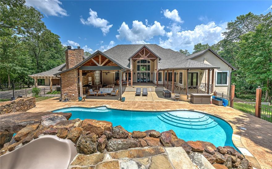 Surrounded by 18.5 gorgeous, rolling acres, this extraordinary remodeled luxury home combines comfort and opulence in the prestigious hills of East Fayetteville. Upon entering this picturesque residence, you'll discover a breathtaking grand entry way, an open concept floor plan, 4 large bedrooms each w/ ensuites & 3 additional half baths.  Perfect for entertaining, this home also boasts custom, high-end finishes throughout, living spaces on both floors, cozy fireplaces, a large updated kitchen with high-end Thermador appliances, game room, 2 wet bars, & so much more!  Enjoy summer parties w/ your own resort-style backyard that features a full outdoor kitchen, built in sound system, fireplace, and your own oasis heated gunite pool w/ waterfall.  PLUS, there’s a 2400 sq ft shop perfect for your next project! W/ remote control window shades, new roof & flooring, an advanced smart home hub complete w/ surveillance as well as many more upgrades throughout, this home has everything you need and more. Make it yours today.