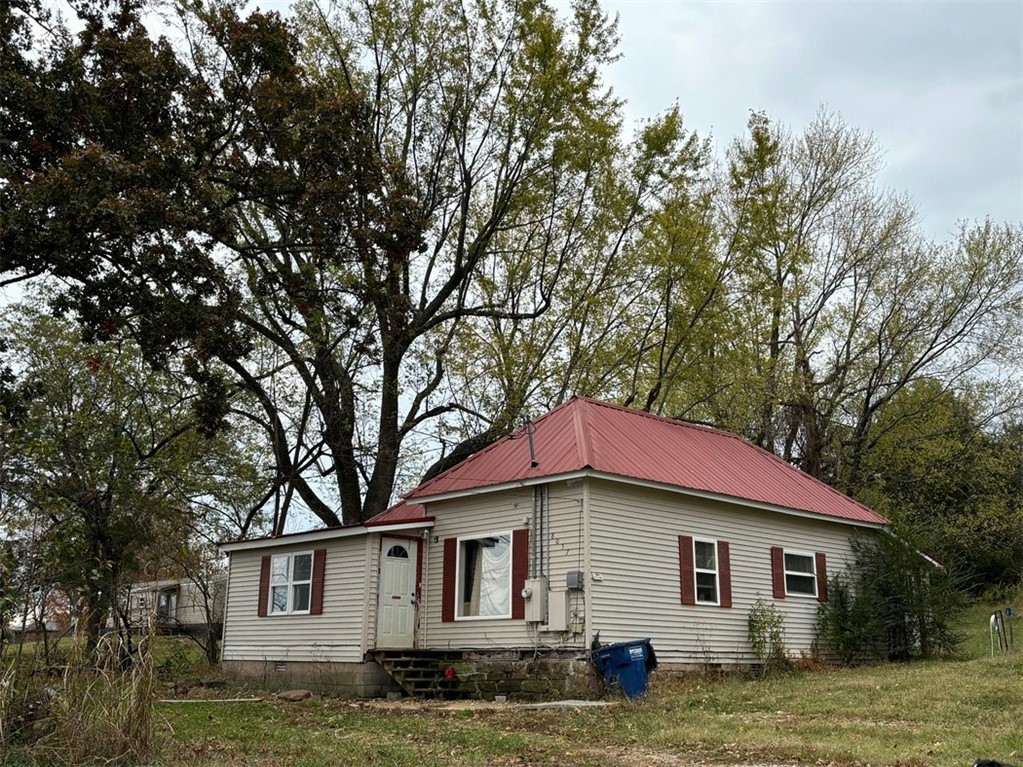The proverbial fixer upper! 3BR 1BA home with vinyl siding, metal roof and CH&A. Home is livable, but will need updates/repairs. Large lot, detached 24x24 garage. In a small community minutes West of Harrison. At this price, check it out soon!