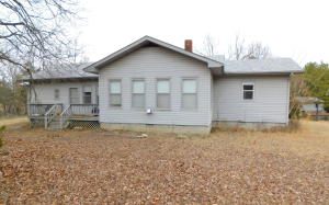 Nice, well built, large home with spacious rooms and many updates. A quiet country setting just off a newly paved county road less than 5 miles from town. Included is a small one room guest house with it's very own kitchen & bathroom. there is also a 24 x 24 shop with a full basement and a green house.