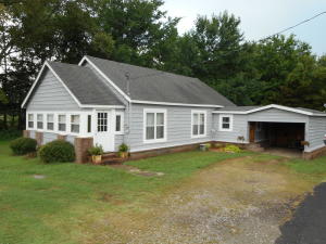Beautiful Red oak floors and custom made maple cabinets make this home inviting. Large living room and open kitchen with dining room.spacious bedrooms with large closets, conveniently located laundry room with same matching cabinets. attached carport with entry door to the home. corner lot offers more parking and a storage building. located close to town in a good neighborhood. make plans to see this home.