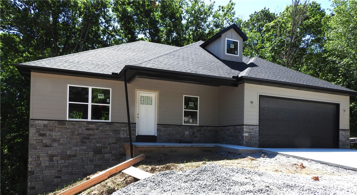 This beautiful custom home is located at a great location in Bella Vista, on .33 acres. The exterior of the home is board and stone. The home features four bedrooms and an office. The living room, kitchen, and dining areas are an open floor plan with one of two wonderful decks to enjoy. A large family room in the basement with access to the second deck, fantastic views, and access to the backyard. The kitchen vent is vented to the outside, with custom-made cabinets throughout the home. A side mount garage door opener for quiet operation of the garage door. The Metfield Clubhouse is one minute away from Golfing and the use of the fitness center. Biking/Walking trails are very close to your new home. Swimming, tennis, a skills park, lakes, and a playground are nearby. Bentonville city limits are just eight minutes away. New Construction on a sewered lot.