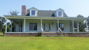 View, View and more Mountain views. Enjoy your morning coffee or your afternoon lemonade from the back porch, the front porch or the screened in porch off the master bedroom. This home offers 3 bedrooms, 2.5 bathrooms and office. The living room has a brick fireplace and opens up to the kitchen and dining area. All this sits on 15.71 acres and 2 large out buildings once used for a packing house.