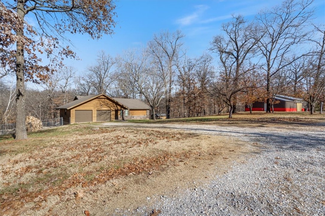 This is it!! 5.74 Acres, Pool and Shop in Bentonville!
This 5br/3bath property is located only 15 minutes from Downtown Bentonville and 5 min from I-49 with beautiful outdoor space, seasonal waterfall/creek views and an inground swimming pool. Modern feel inicluding an open floor plan with cathedral ceilings as well primary bedroom, kitchen, living room and office/bedroom on the main floor. Downstairs is a second living/common area with 3 bedrooms, a kitchenette and a walk out patio to the gated inground pool. The 30x60 shop was built in 2018. This property checks all the boxes! Don't miss out!!