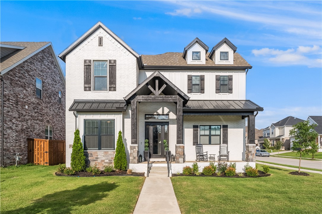 Located in the coveted Aurora Subdivision in Bentonville, this 2023-built home offers the perfect blend of modern elegance and everyday comfort. With 4 spacious bedrooms, 3 full bathrooms, and 2,163 sqft of thoughtfully designed living space, this home checks every box. The open-concept layout is filled with natural light and features soaring vaulted ceilings, a stylish kitchen with sleek finishes, and a seamless flow into the dining and living areas—ideal for entertaining. The main-level primary suite is a true retreat, boasting a spa-like bathroom with a soaking tub, walk-in shower, dual vanities, and an oversized closet. Upstairs, three generously sized bedrooms each offer walk-in closets and share a large bathroom with double vanities. Step outside to a covered patio perfect for relaxing or hosting. Enjoy access to incredible community amenities including an adult pool, kids’ pool, clubhouse, playground, and scenic walking trails. All just minutes from Bentonville’s best shopping, dining, and schools.