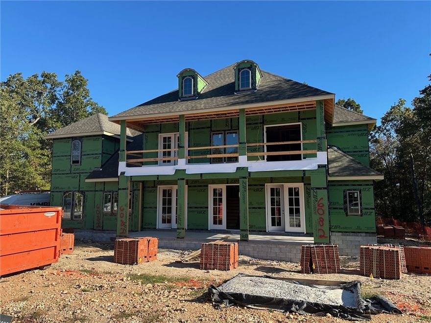 Welcome to this new single-family home in Fayetteville’s peaceful Blackberry Ridge, designed by Lane Crosno Designs. Upon entry, you're greeted by a two-story ceiling and staircase. To your left is the formal dining room, and to your right, French doors open to the guest bedroom or office. Continue into the open living area with a vaulted ceiling that includes the kitchen and living room. The kitchen features an island, quartz countertops, Cafe appliances, and a butler's pantry with a mini fridge. Engineered hardwood floors extend through the main areas, including downstairs bedrooms and stairs. The owner’s suite offers a vaulted ceiling, walk-in closet, and spa-like bath with dual vanities, walk-in shower, freestanding tub, and private water closet. Upstairs, you’ll find a bonus room, three bedrooms, two baths, and a balcony. The three-car garage is prewired for an EV charger, and the covered porch with gas line and CAT6 hookup overlooks the wooded backyard. *Agent Owned*