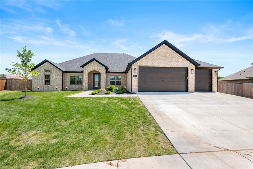 Beautifully built 2023 one level home offering 5 bedrooms and 3.5 baths with an open-concept layout perfect for everyday living and entertaining. The kitchen features custom floor-to-ceiling cabinetry and a double oven. The primary suite includes a tiled shower and a spacious wrap-around closet. Enjoy a large covered back porch with an outdoor fireplace, all on a private .45-acre lot in a quiet half-cul-de-sac. Just 10 minutes to Bentonville Square and 15 minutes to the Walmart Home Office.