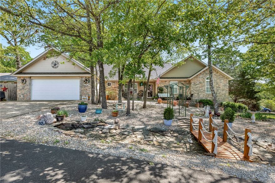 Tucked into the natural beauty of Bella Vista, this home feels welcoming the moment you arrive. The thoughtfully designed front yard create a peaceful, garden-like setting with winding paths, mature trees, & spaces to enjoy the surroundings. Step inside to a bright & open living room with vaulted ceiling, skylights overhead, & plantation shutters that add timeless character. The layout offers comfortable living with 3 bedrooms, a spacious kitchen with room to gather, both formal & casual dining spaces, & a sunroom that invites you to slow down & enjoy the beautifully landscaped backyard. Step outside & you’ll find even more to love—two decks for relaxing or entertaining, including one with a pergola, plus an additional lot that provides extra privacy & breathing room. Extra outdoor features include a shed with an automatic door, extra vehicle parking, RV parking pad & crawl space storage. This home has been truly loved and cared for, inside & out. *Just half a mile from Dogwood Golf Course and Metfield Rec Center.
