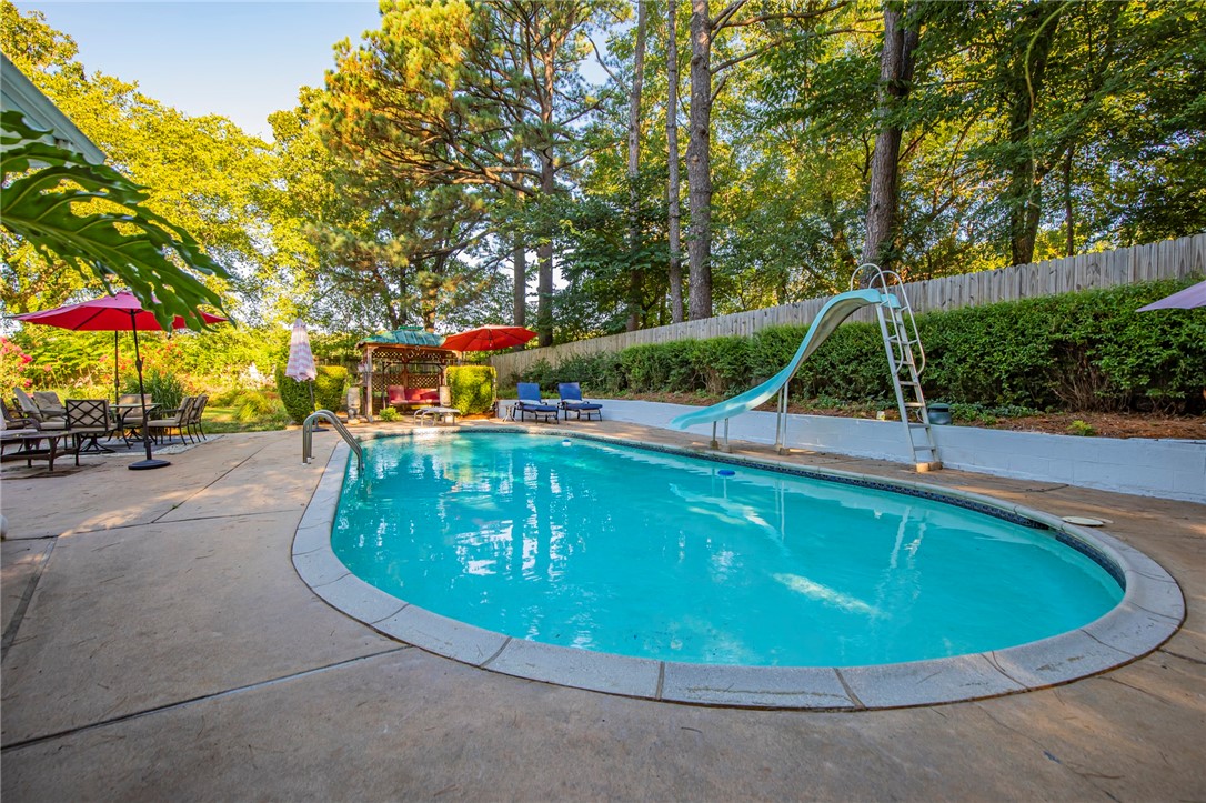 Come see this charming 3 bedroom, 2 bath home that's ready for your personal touch! Nestled on over an acre, this home offers an in-ground pool with a diving board, perfect for summer fun. Entertain guests in the formal dining room and spread out in two spacious living areas. Embrace the opportunity to customize and make this house your dream home.