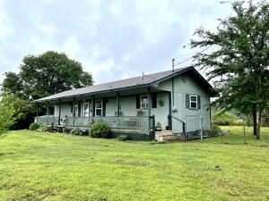 2 bed 1.5 bath home on peaceful setting outside city of Ozark. Large covered deck overlooking the Ozark mountains. Fenced backyard. Storm shelter and 0.68 acres. Inside features open concept kitchen and living room with split floor plan.