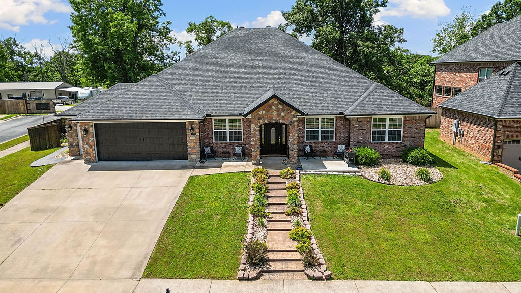 Welcome to 4206 NE Kenton in the desirable Kensington neighborhood—just minutes from the new Walmart Campus! This 5-bed, 3-bath home features an open floor plan, dedicated office and built-ins in the dining room. The heated and cooled enclosed patio adds year-round living space, while the open patio includes a built-in bar and commercial-grade vent hood—perfect for grilling and entertaining. Primary bedroom and ensuite with 3 additional bedrooms are located on the main floor. Upstairs, a spacious bonus room with full bathroom and fireplace (added in 2009 after removing the spiral staircase) doubles as a media room, complete with projector and screen. The backyard is wired for a hot tub and the pergola conveys with the property. Enjoy thoughtful upgrades and flexible living spaces in one of Bentonville’s most convenient and sought-after neighborhoods. New Roof 2025, 2 AC units replaced with in the past 2 years, new gutters 2025.