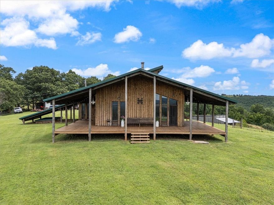 Just over an hour from Fayetteville, this 200± acre retreat on the Madison/Carroll County line offers a rare blend of seclusion and access. Located 1.3 miles south of Hwy 412 between Marble and Dryfork, and near the Buffalo & Kings Rivers. Includes a 1436 sq ft custom Austrian-style oak/walnut home (1987) with 1000+ sq ft of covered porch, 45± acres of pasture, 155± acres of hardwood timber, 2 ponds, 2 miles of internal roads, and full fencing (some storm damage gaps). Also features a 26x50 barn with electric, 924 sq ft mobile home (storage), and older 3346 sq ft home and 26x48 barn (no value). Excellent deer, turkey, and occasional bear; powerline corridor ideal for hunting. Wild blackberries and dewberries are plentiful, including a large patch near the house. Livestock currently on-site with regenerative farming practices in place. A true Ozark getaway with natural beauty, wildlife, and functional infrastructure.