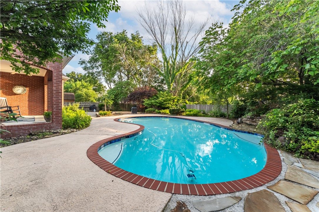 Introducing your next home, where every day feels like a vacation. This single-owner property has a secluded Backyard Paradise & a prime location with access to the Razorback Greenway right across the street. The location couldn’t be more convenient. It is close to Bentonville Square, schools, shopping, & is a quick jaunt to the Walmart HO (current and future).
Step into the open floor plan and be greeted by pool views from the kitchen & living areas. The kitchen has been completely updated with top-of-the-line appliances, quartz countertops, a stylish backsplash, a farm sink, & coffee bar.
The main floor features a dedicated office & primary, while the upstairs has 3 additional bedrooms, 2 with their baths. Need more space? The property offers a large bonus room that can easily be converted into a fifth bedroom, complete with a walk-in closet.
Rest easy knowing that this property has been well-maintained. Recent updates include a 40-year roof, a newer HVAC system, & new flooring throughout.