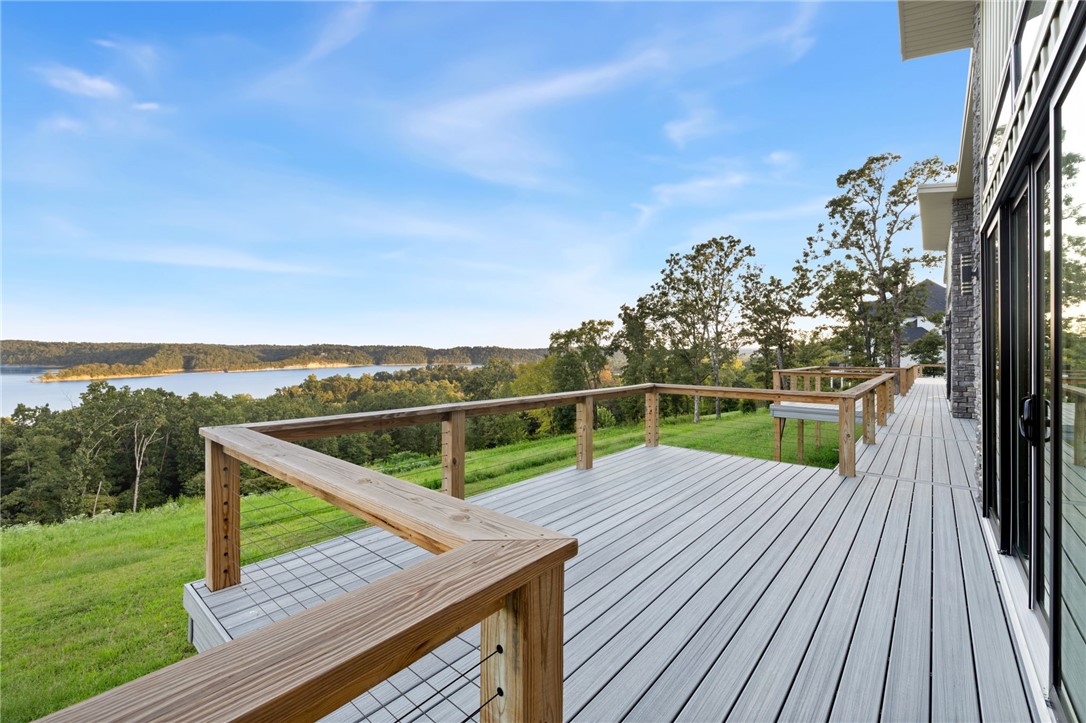 Completed in 2024, this nearly new custom one-level home sits on a spacious 1.59-acre lot with stunning year-round lake views! The open layout offers 3 bedrooms, 2 full baths, a study, and a dedicated laundry room. The chefās kitchen showcases custom soft-close cabinetry, quartz countertops, an island, and pantry. Quality finishes include tiled showers, crown molding, a neutral palette, and an oversized 3-car garage. An expansive back deck spans the length of the homeāperfect for entertaining or relaxing while taking in the serene views. Just 6 miles from downtown Rogers, this property is an ideal primary residence or second home retreat!