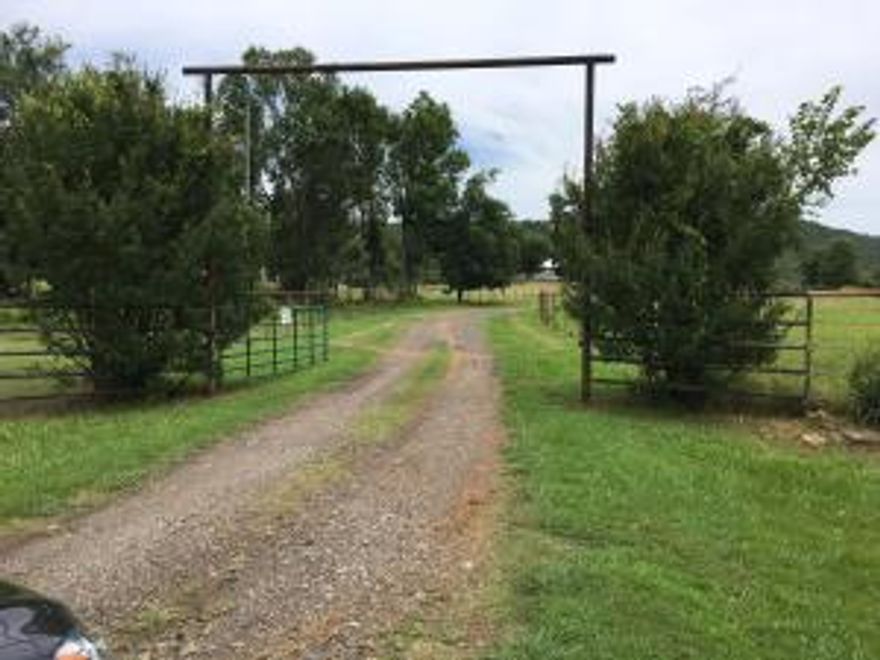 25+\- acres, outdoor arena has lights and a cattle return, set up to rope in, approximately 100x180. Indoor has lights and is 75x175, warm and dry in the winter! Gravel drive to the back for parking to either arena. Circle drive in front of house. Barn has 8 stalls, six 12x12 and two 12x24 (these have an in/out option), 12x24 tack/feed room, a 12x12 wash area with hot water. 14 foot lean to off west side of barn for storage. Four horse walker and two storage buildings. Most fencing is pipe and cable. Some fencing suitable to contain roping steers. 996 feet I-40 frontage, less than a mile from an exit. Pottsville school district, 10 minutes to Russellville. Three hours +\-from Tunica, Tulsa, Texarkana, Carthage, less than 5 hours to OKC.Apartment in the barn is 1 bedroom, 2 bath, washer/