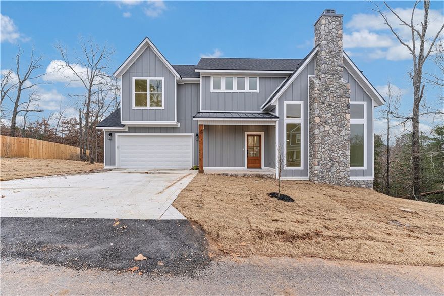 Experience modern comfort in this new construction 3-bedroom, 2.5 bath, 1817 sq ft home on peaceful Naworth Ln in Bella Vista.  Step into a bright, open layout featuring a spacious living area around a beautiful fireplace-perfect for cozy evenings and entertaining.  The contemporary kitchen offers ample counter space, stylish finishes, and seamless flow into the dining area.  All three bedrooms are located upstairs, including generous primary suite with a "spa feel" bath and great closet space. Two additional bedrooms and a full bath provide flexibility. Enjoy the serene, wood setting from your private deck- ideal for relaxing or outdoor dining.  As an added bonus, the seller is offering an additional 2-year home warranty for peace of mind.  With quality craftmanship, great curb appeal, and close access to Bella Vista's trails, lakes, and amenities, this home is a must see!