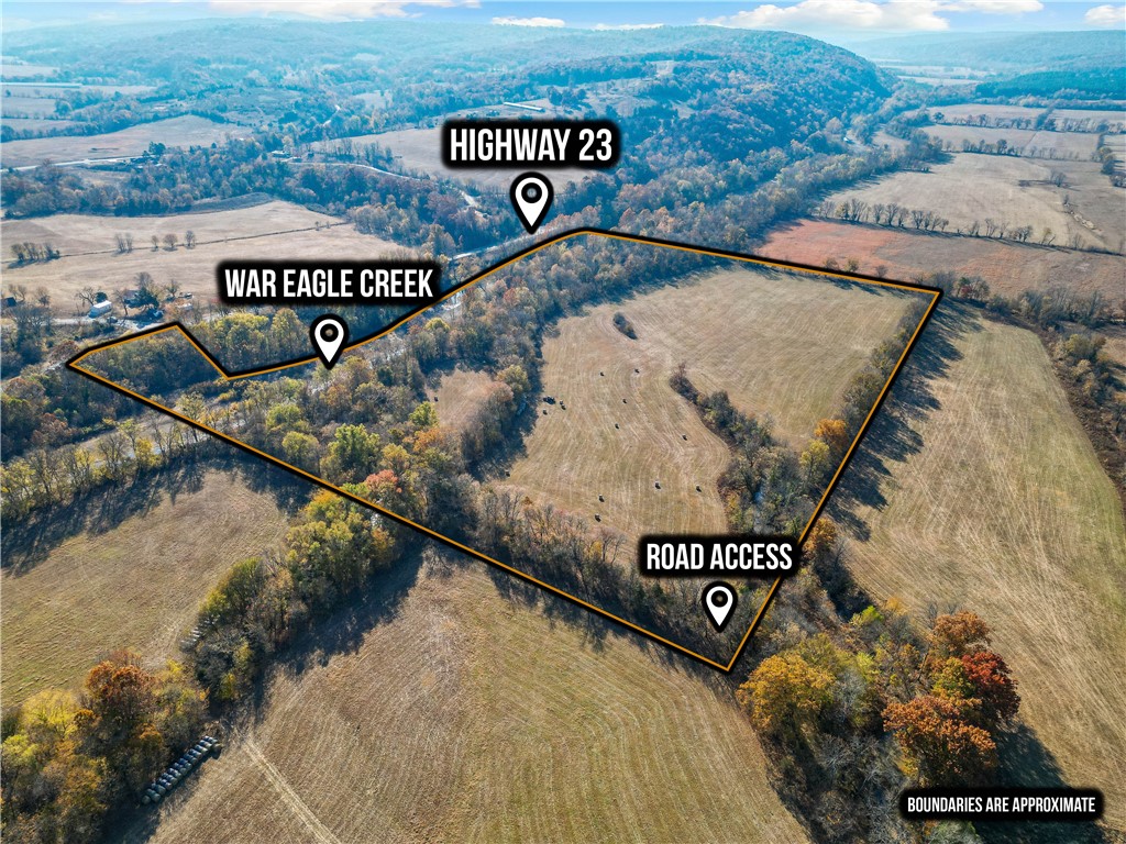 Secluded yet accessible, this property offers ideal space for hunting, camping, cattle, or simply enjoying nature. Surrounded by woods with the War Eagle River running adjacent, it provides a peaceful, rural setting just minutes from town. Neighboring lands are used for hay production, adding to the serene atmosphere. Located just a short distance from town, this is an exceptional spot to build your dream retreat or simply enjoy nature in a peaceful, remote location