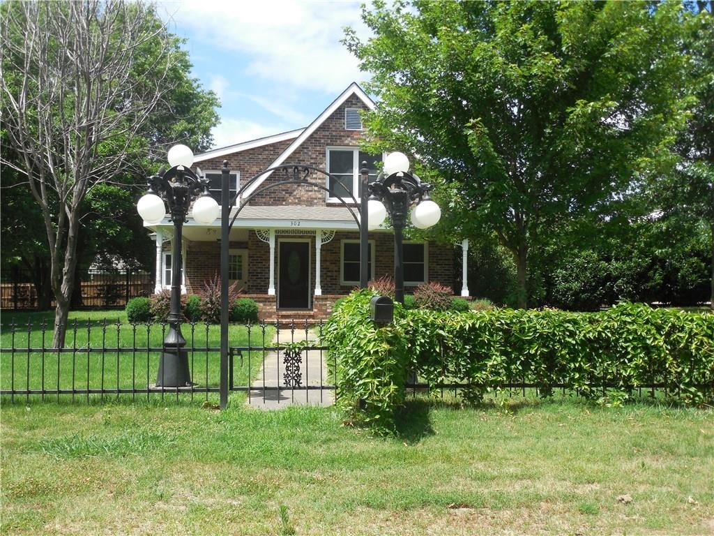 Welcome home! Relax at the end of your day in this lovely brick home on three private landscaped lots surrounded by wrought iron fencing! Large trees provide privacy and shade and yard is an entertainers dream! Home features warm wood ceilings and accents throughout, granite counters in kitchen and baths, and tile showers. First level has tile floors throughout, upper floor has hardwood and carpet. 30x40 detached garage provides plenty of parking and shop space with boat or RV parking alongside.