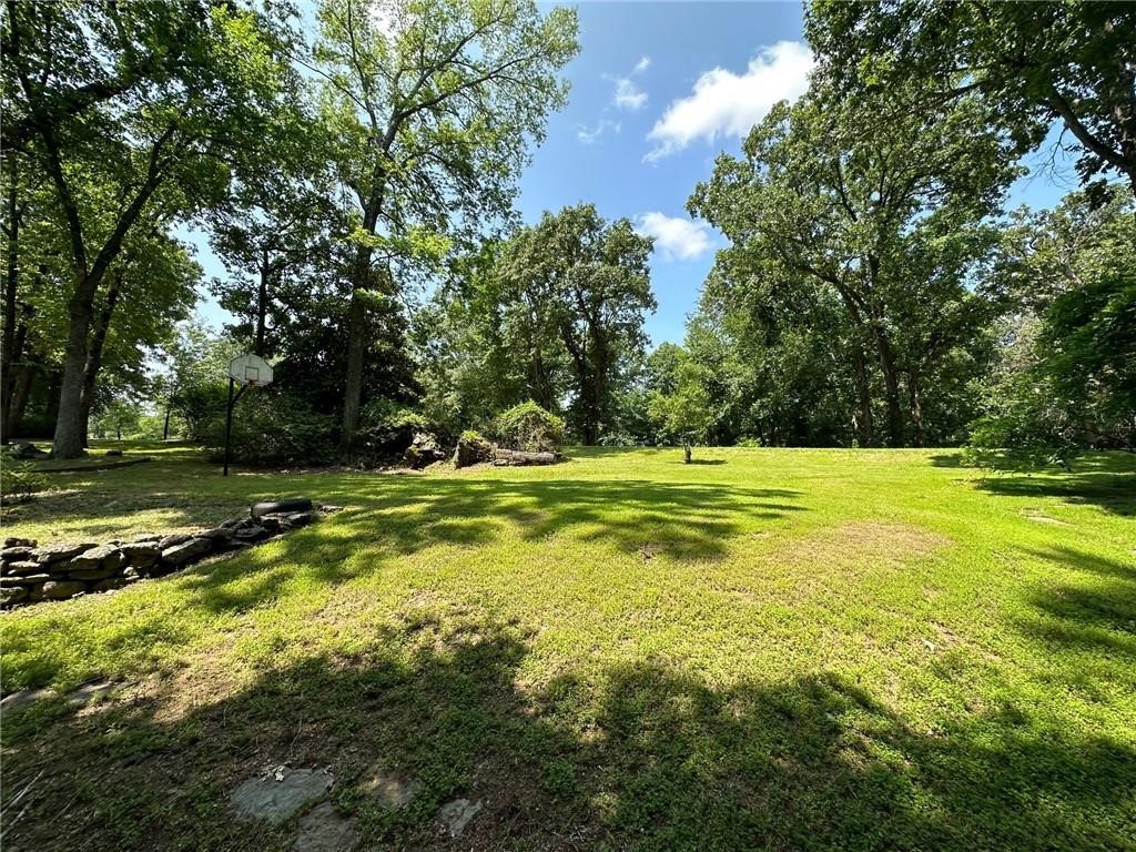 NO POA! Beautiful 2.3 acre lot, GREAT location just 2 minutes to Lake Atalana, less than 3 minutes to Downtown Rogers! Build your dream home in the very desirable Hyland Park Subdivision! Easy access to trails at Lake Atalanta and the Greenway trails. Only 5 miles to Beaver Lake and Prairie Creek Marina, 12 miles to Hobbs State Park, 20 minutes to the new Walmart Home Office and Downtown Bentonville! Rogers public water! Perc test has been completed by previous owner and will support a 4-bedroom house, survey done in 2023. Great location to build your dream home or Airbnb!