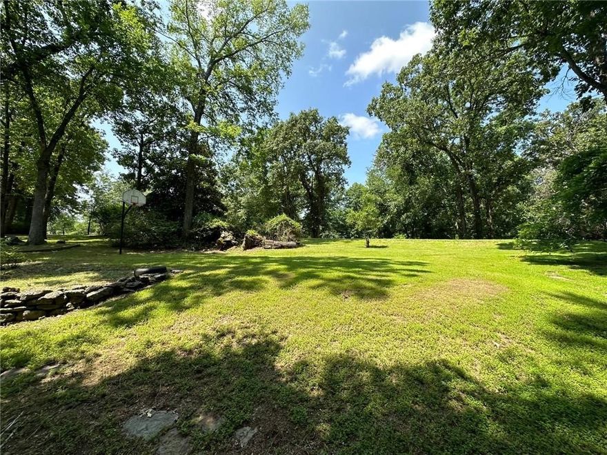 NO POA! Beautiful 2.3 acre lot, GREAT location just 2 minutes to Lake Atalana, less than 3 minutes to Downtown Rogers! Build your dream home in the very desirable Hyland Park Subdivision! Easy access to trails at Lake Atalanta and the Greenway trails. Only 5 miles to Beaver Lake and Prairie Creek Marina, 12 miles to Hobbs State Park, 20 minutes to the new Walmart Home Office and Downtown Bentonville! Rogers public water! Perc test has been completed by previous owner and will support a 4-bedroom house, survey done in 2023. Great location to build your dream home or Airbnb!