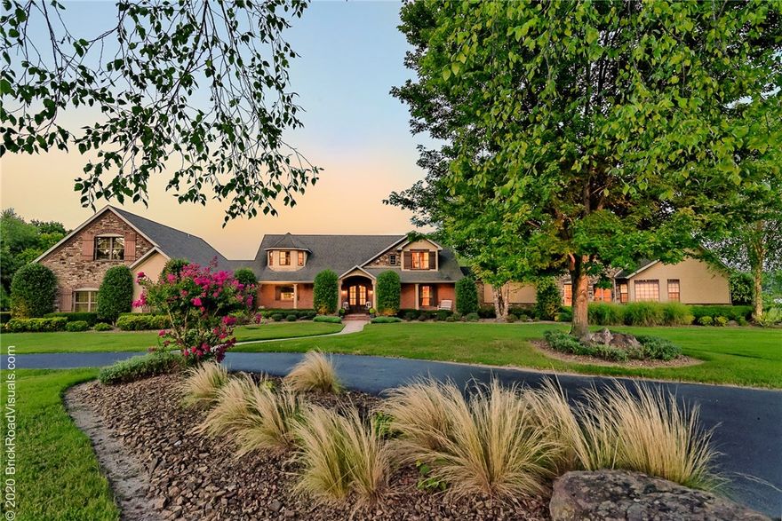 Make Your Dreams a Reality with this luxurious, lakefront peninsula paradise with over 1200 ft of easy access shoreline located in the heart of the Ozark Mountains!  Nestled on 23 gorgeous acres on beautiful Beaver Lake in NW Arkansas, every day is a vacation with your own custom, 9 hole golf course, private 8 slip boat dock with 3 power lifts and 2 SeaDoo slips and party/swim deck!  Entertain in style and be entertained in over 6200 sq ft of luxurious, fun, upbeat, living space that sleeps up to 20 people and includes 5 bedrooms, 5.5 baths, a cook’s gourmet and outdoor kitchen with grill and wood fired oven, a media room with wet bar, fitness center and incredible master suite with private living room, office and fitness room! Includes detached 3,000 sf, 4 bay garage!  Unique, one of a kind offering - turn-key with most furnishings included and ready for lucky new owners! Far too much to mention, be sure to check out the Virtual Tour!