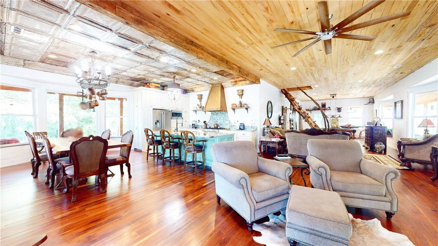 Discover your dream retreat on 61 secluded acres outside Huntsville, AR. This artisan-decorated home boasts 2 spacious bedrooms, 3 elegant bathrooms, and is fully furnished with high-quality pieces perfectly matched to the home. The open-concept living area, gourmet kitchen, and primary suite with a luxurious en-suite bath offer the perfect blend of comfort and style. A charming guest house attached by a shared deck features 4 bedrooms, 1 1/2 baths, and a fully equipped kitchen, ideal for visitors or extended family. The property includes a fully equipped shop and barn, with all farm equipment and tools included. ENTIRE property is powered by a backup diesel generator. Enjoy endless outdoor activities on your expansive estate, from hiking to farming. This unique property combines modern conveniences with rustic charm, offering peace, privacy, and unparalleled beauty. This custom hand-built home is adorned with artisan decor and reclaimed/repurposed material - ask for Feature Sheet for a list of all items included.