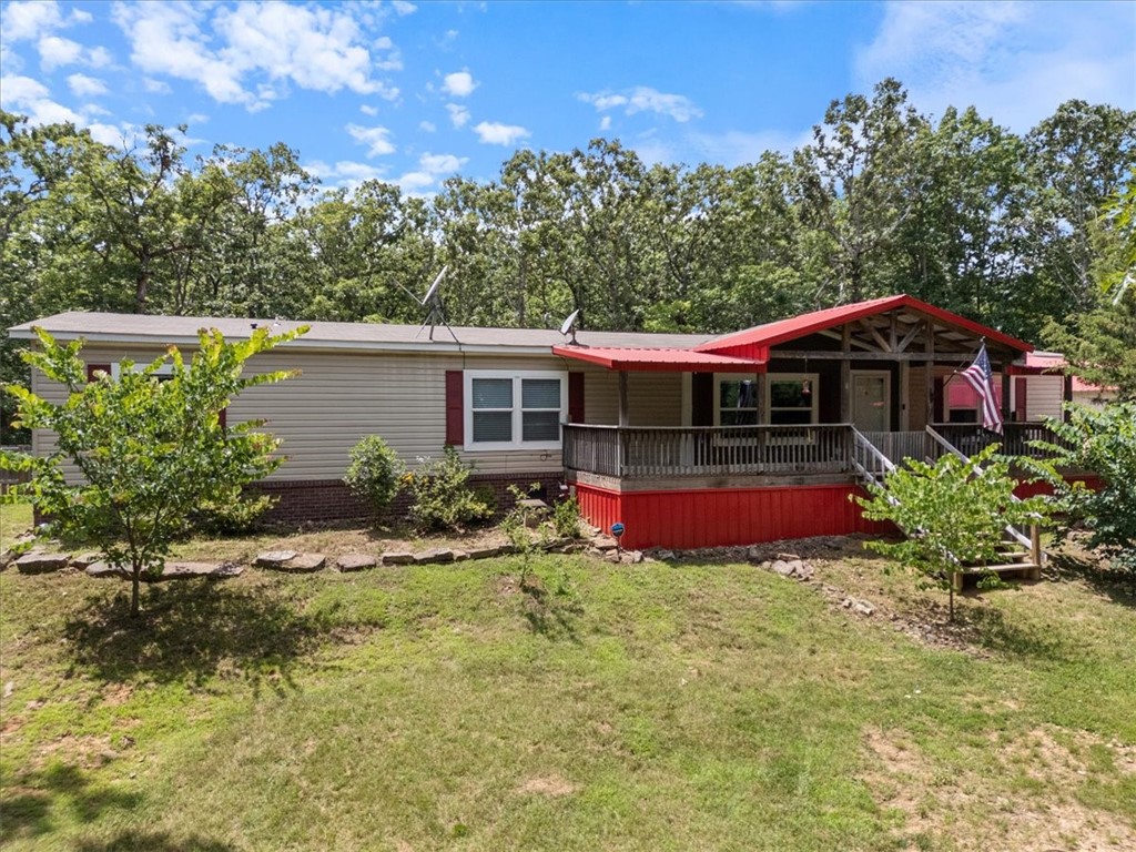 Welcome to your country retreat - minutes to town! This spacious 3-bed, 2-bath home on 8.11 acres is designed for comfort & exceptional outdoor living. The full-length screened back porch is a showstopper—perfect for relaxing & entertaining. Step into the yard to find a tree house, composting outhouse, picturesque gazebo and a chicken coop—all offering endless opportunities for outdoor enjoyment and sustainable living. Inside, the open-concept kitchen and living area are ideal for gatherings, featuring abundant cabinetry, a large island, modern appliances, walk-in pantry and a cozy dining nook. The living room boasts a built-in entertainment center, while the expansive primary suite offers a luxurious ensuite and walk-in closet. Additional highlights include a dedicated office with OzarksGo, bonus living area, spacious laundry, whole home surge protector, storage building and garage/workshop with an EV Charger. Storm shelter, fridge & even the chickens can convey with acceptable offer! This property is a must-see!
