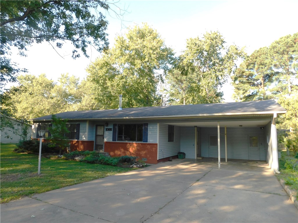 Classic 1960 home with lots of character, warmth and appeal! Livingroom boasts hardwood floors and Knotty pine paneling! Separate mother-in-law suite, family room, office or apartment apprx 450 sq. ft is perfect for many uses! Extensively landscaped with lots of trees, flowers and numerous surprises tucked here and there. Wood burning fireplace with lots of wood behind the storage shed. While the home retains lots of 1960's charm the kitchen has been updated along with double-paned windows.  
Utility room/closet off of the carport contains the HVAC system, water heater and W/D hook-ups.