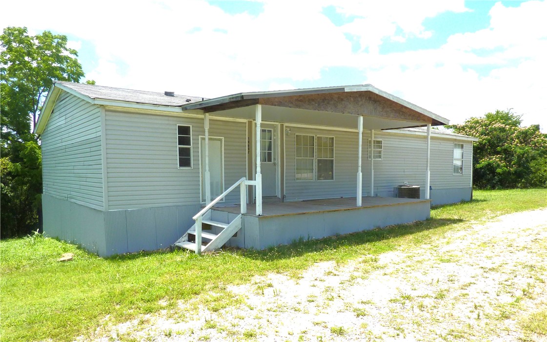Double wide Mobile Home on 8 acres near St. Joe. Open floor plan with eat-in kitchen and laundry room. Large Patio/Deck off living room, Central heat & air. Main bedroom has large walk-in closet. Main bath features Garden Tub for relaxed bathing. Concrete block room would make an awesome storm shelter/workshop with some clean-up. Needs a little updating & TLC.