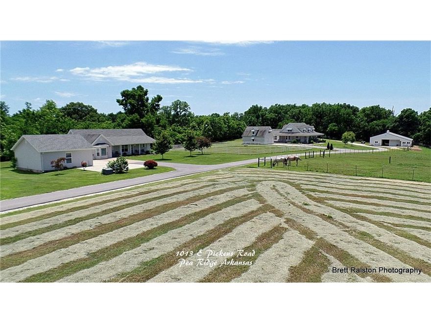 This is it horse lovers! The ultimate country property, ready for move in, convenient and unbelievably scenic. The sight of gracefully rolling green pastures, tall strong hardwoods, picturesque pond and windmill, and quaint little milk barn is only part of the charm of this stunning farm. Watch your ponies frolic from the vast wrap-around porch of the impressive main house or take a short walk to the lovely guest house or barn. You CAN have the best of both worlds, this is the proof.