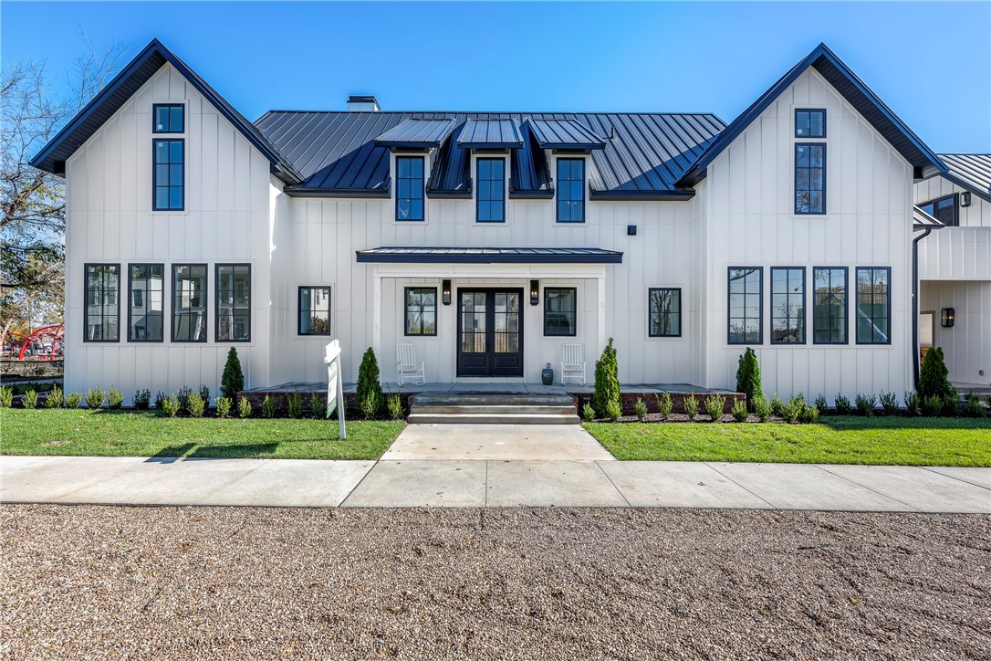 Welcome to The Park House, a stunning architectural gem in downtown Bentonville. Steps from The Momentary and the new Walmart Campus, and located right on Austin-Baggett Park, this home offers nearly 5,000 sq. ft. of luxury plus 2,500 sq. ft. ready-to-finish space. Designed for entertaining, the main level boasts a retractable glass-wall opening to an English-style courtyard. Inside, white oak floors complement a chef’s kitchen with a 48” WOLF range, double ovens, and cabinet-paneled built-in fridge. An oversized butler’s pantry with a coffee bar adds convenience. The main level also features a guest suite and park-view office. Upstairs, you will find the family's private sanctuary area with a spacious family room, two en-suite bedrooms, and an elegant primary suite. The unfinished areas, that add value, to this incredible home include a full basement that is framed and ready to finish out and future guest apartment with private entrance above over the garage. Experience The Park House—where luxury meets lifestyle.