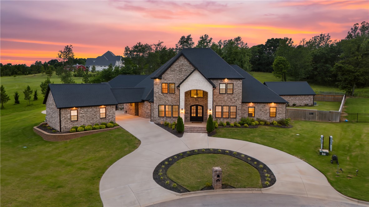 Executive living meets family comfort in this exceptional Haxton Estates retreat. Nestled on 1.12 private acres at the end of a cul-de-sac, this home offers the perfect balance of luxury and livability. After a short drive from the Walmart Home Office, unwind in your heated pool, host clients or friends on the covered patio with fireplace, or enjoy quiet evenings in the media room. The spacious layout includes a gourmet kitchen with quartz counters and custom cabinets, home office, media or game room, large family room, and flex spaces for work or study. The primary suite is a true escape with two walk-in closets, 4 person sauna, and private gym. Each bedroom has it's own private bathroom. Separate guest and pool houses offer privacy for visitors or live-in help. Zoned for top schools and close to Pinnacle and Shadow Valley—this home is made for modern executive families.