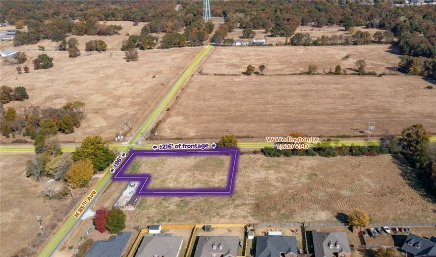 This prime commercial parcel is situated on a highly visible hard corner with approximately ±216 linear feet of frontage along W Wedington Drive/Highway 16 and an additional ±96 linear feet on N 85th Avenue. Utilities are available at the street, providing a cost-effective and development-ready opportunity. Zoned C-1, the property offers exceptional flexibility for a wide range of uses, including restaurants with drive-thrus, neighborhood retail and shopping centers, offices and studios, gas stations, sidewalk cafés, cluster housing, small-scale production, government facilities, and short-term rentals. Located just 4.7 miles from I-49 and benefiting from strong traffic counts of approximately 92,000 vehicles per day, the site offers excellent exposure and convenient access to the region’s major transportation network.