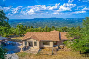MILLION DOLLAR VIEW, sunlit spacious home, and 10 acres!! This move-in-ready 3,840 SF home was completely remodeled in 2016 down to stud walls including new roof, CH&A, windows, wiring, plumbing, flooring, spray foam insulation, septic and siding. It features 4BR-4BA including 2 master suites, an open floor plan, custom kitchen cabinets, kitchen island, fireplace, large windows, and beautiful hardwood floors! Enjoy the porches, covered porches, and covered graveled picnic area with outdoor sink. Outdoor benefits include the oversized 2 car garage (32'x32'), barn (12'x24') with 2 stalls, fenced garden area, 2 RV hookups with septic and water. Approximately 2 acres of fenced pasture near the barn. Close to Jasper, Buffalo River, and National Forest.